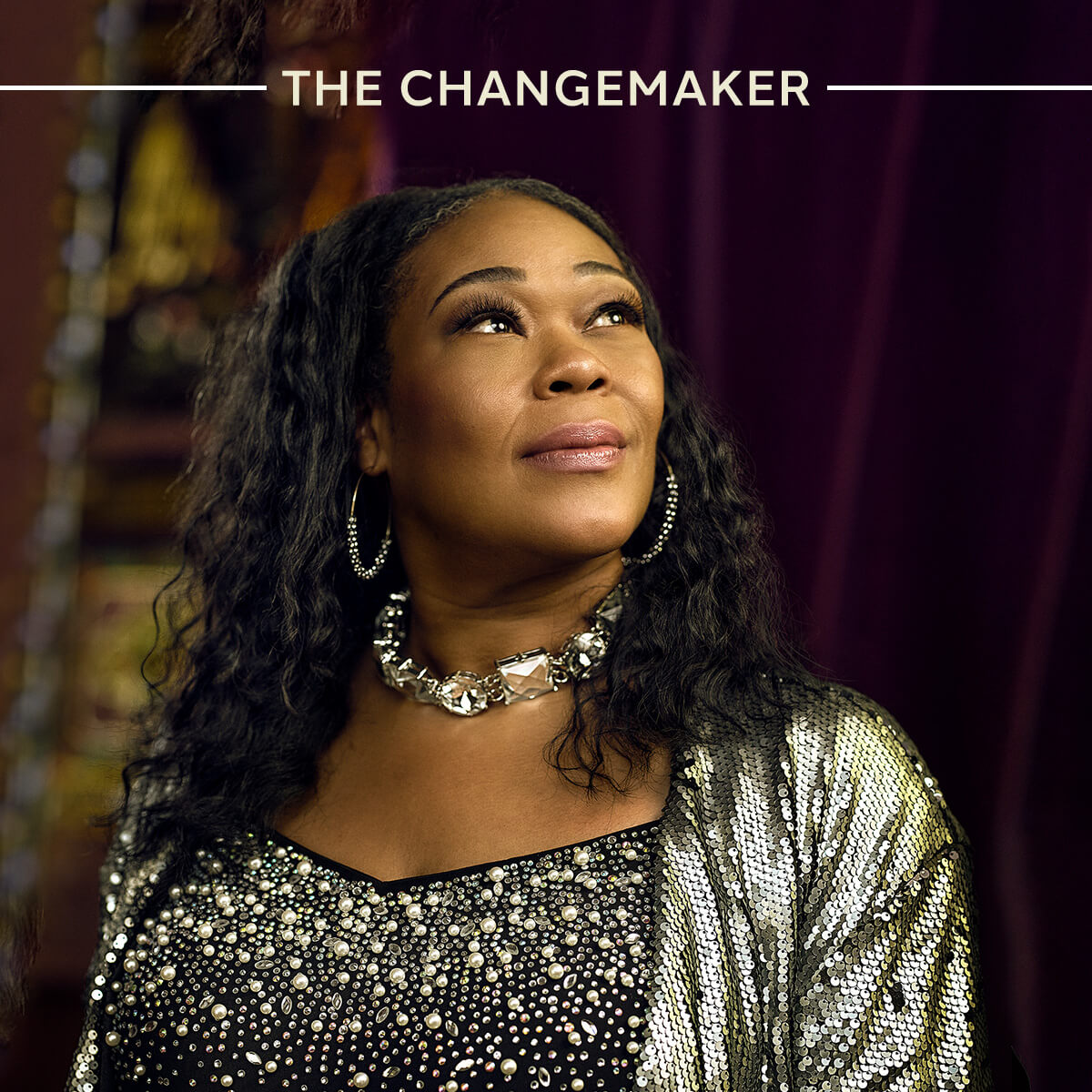 Text reads The Changemaker over a woman looking confidently into camera